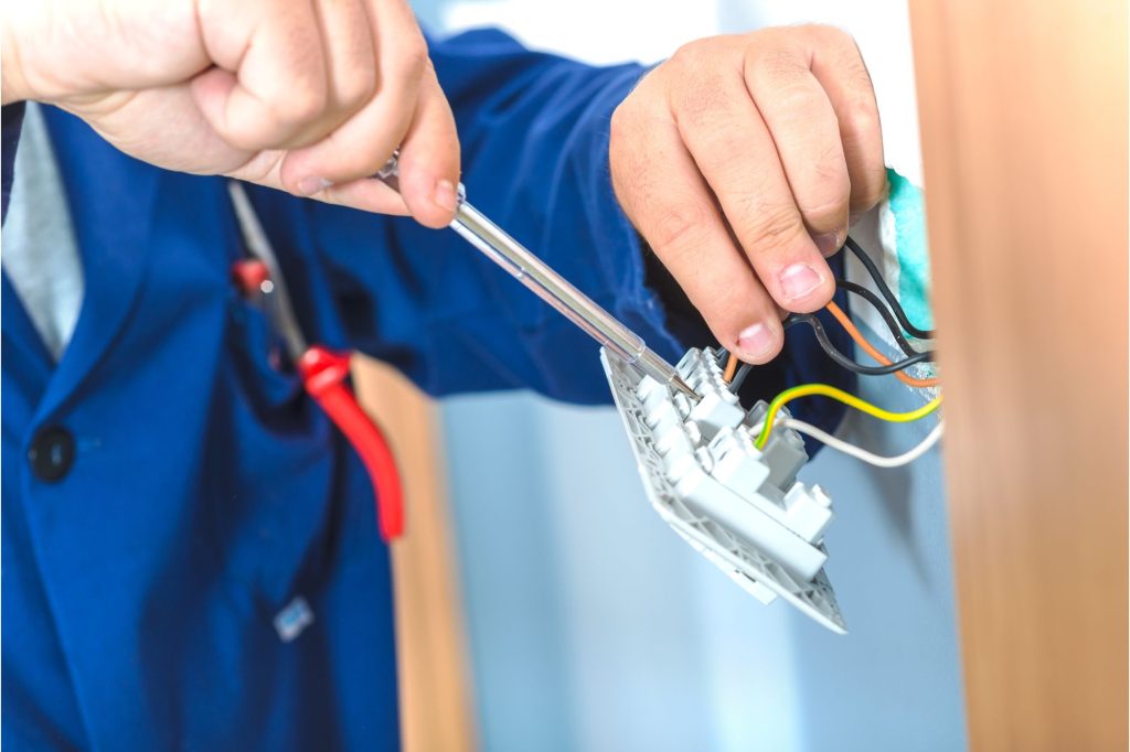 man fixing sparks box in London By Sol-Lux Electrical