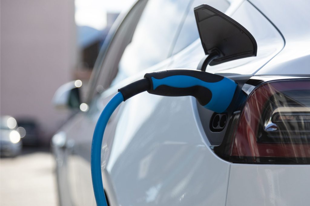 car charging point power lead going into white car